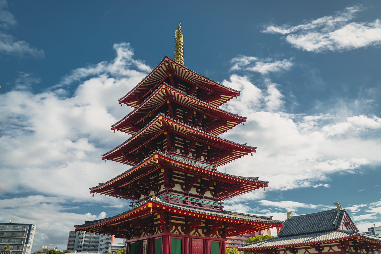 Capture the beauty of the iconic Shitennoji Temple pagoda set against a vibrant blue sky in Osaka, Japan.